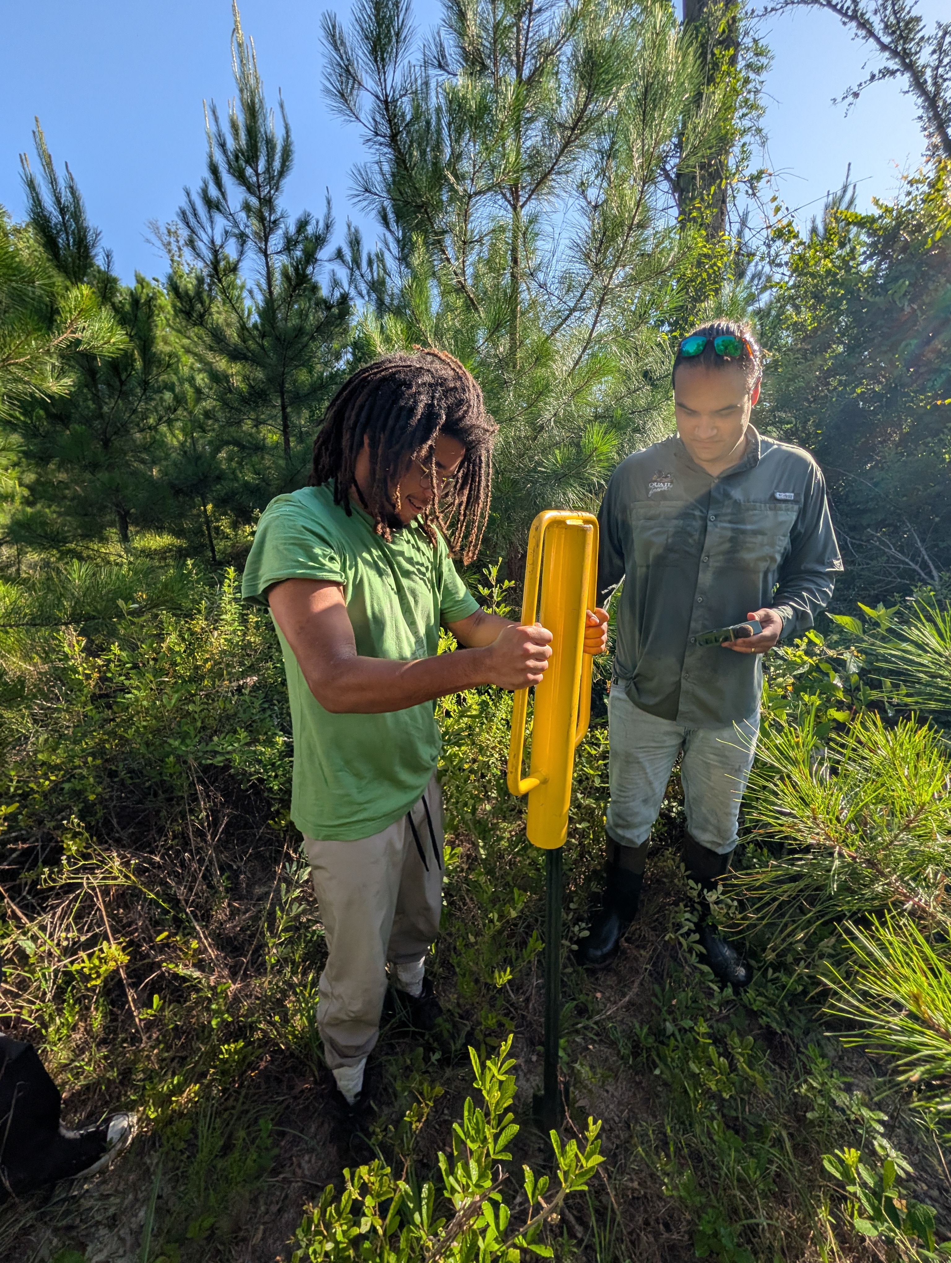 Adam placing the pole in ground w_ Nick.jpg